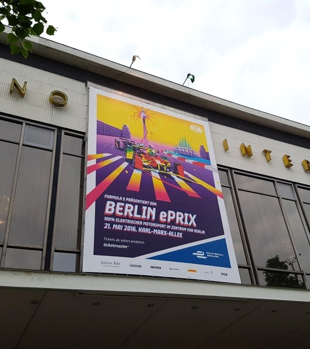 Berlin ePrix poster installation showing FIA Formula E campaign artwork displayed on a city wall, bringing the electric racing illustration into a real event setting.