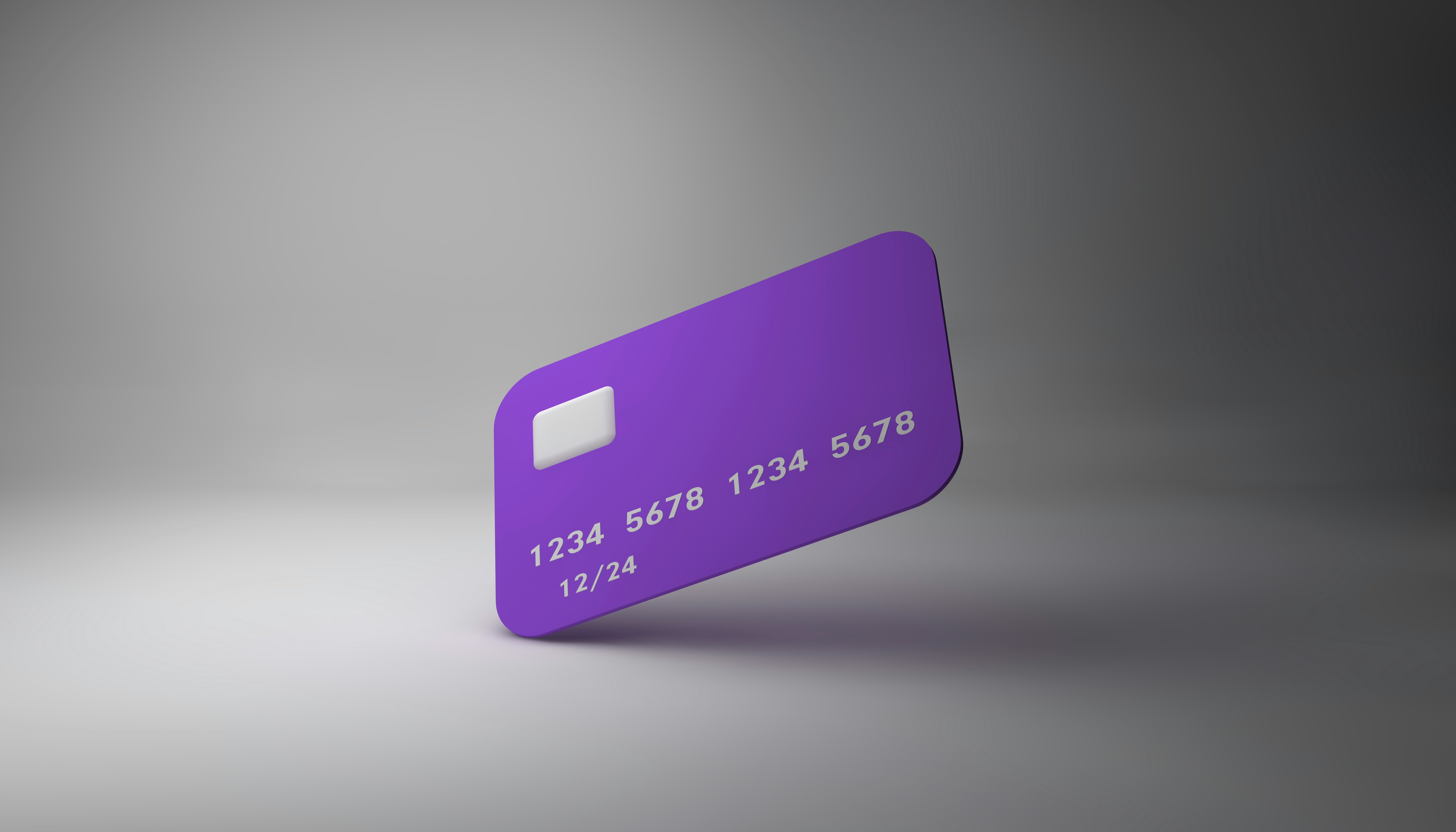 a debit card with PAN numbers floating over a gray gradient background