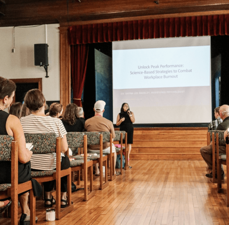 A photo of Dayna presenting and gesturing