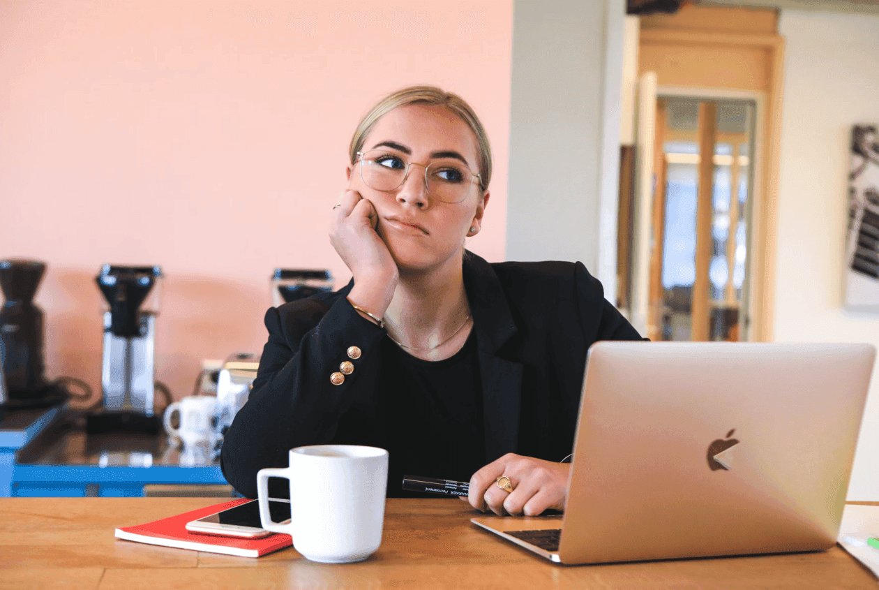 Recruiter woman with coffee and laptop overwhelmed by work