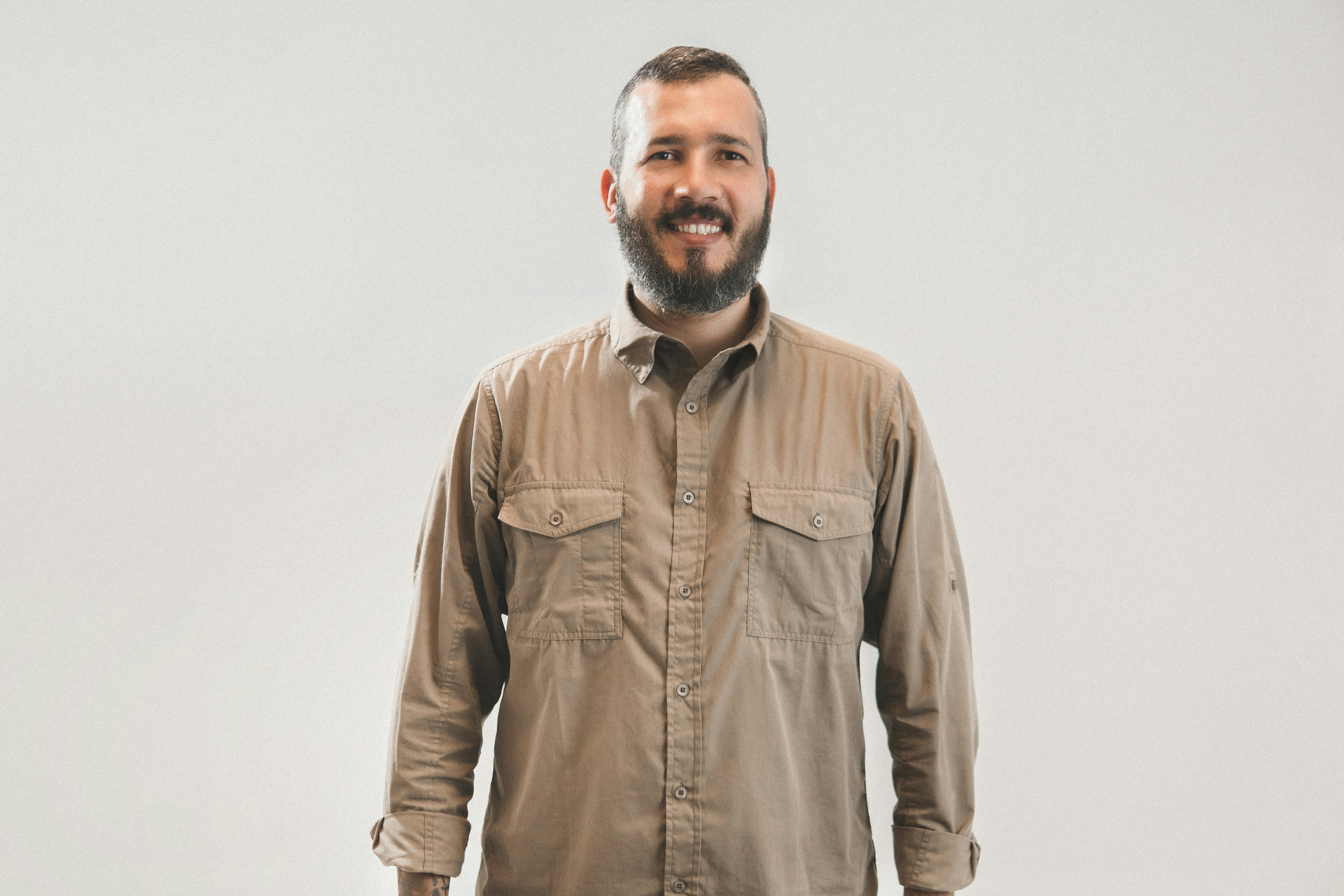 smiling man in brown dress shirt on focus photography