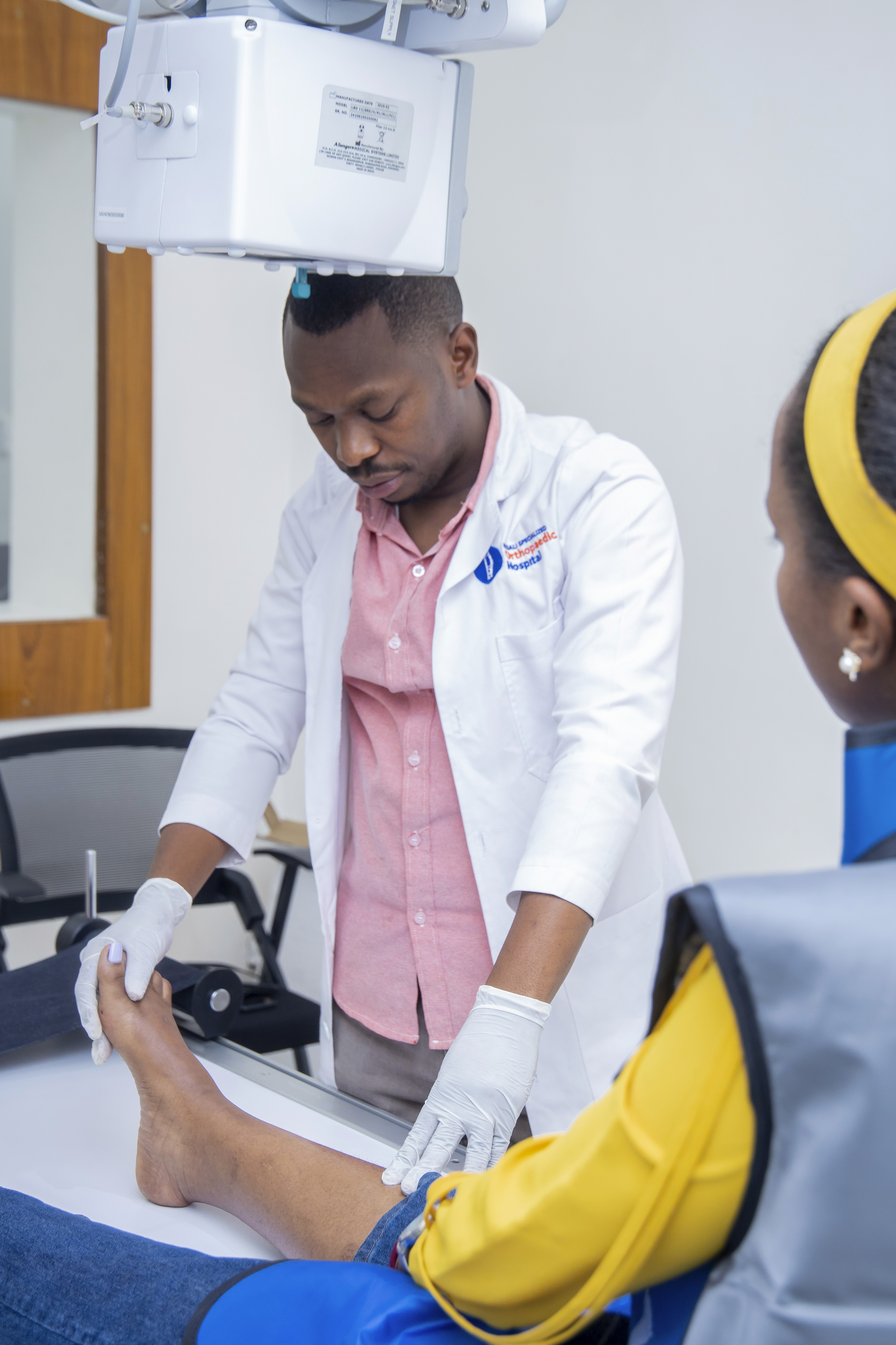 Female doctor discussing over tablet pc with patient standing in hospital