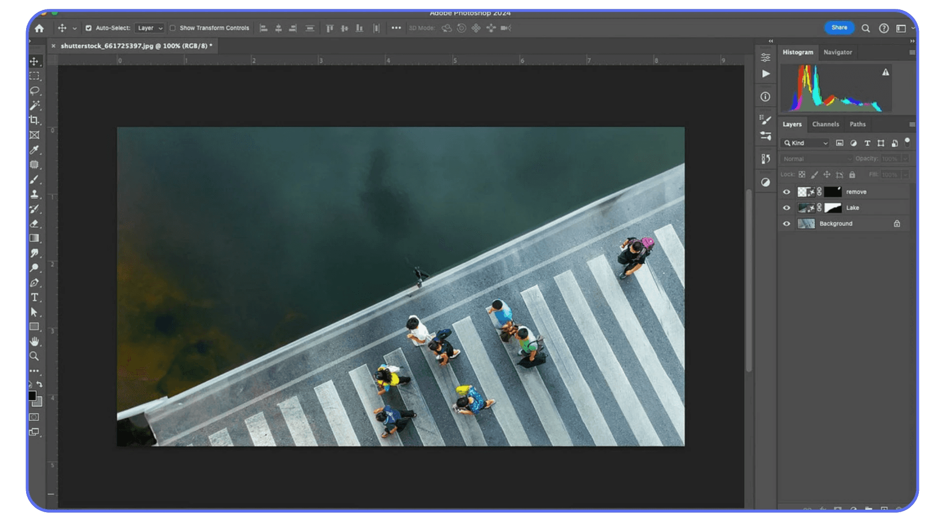 Top-down photo of people on a crosswalk being edited in Adobe Photoshop, showcasing object removal tools and histogram panel.