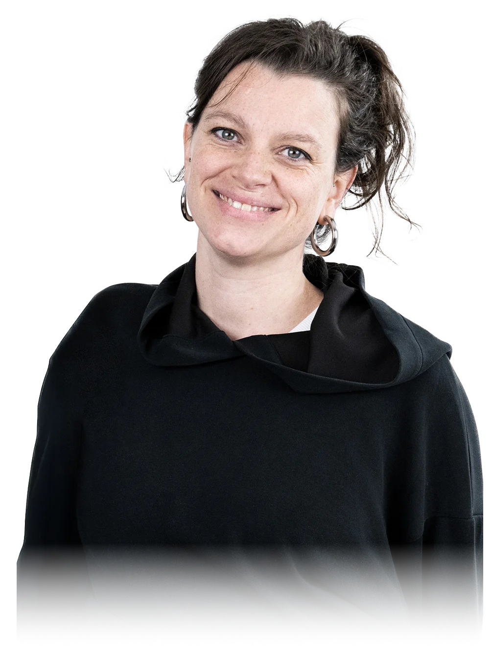 A woman sits cross-legged with eyes closed, wearing a white blouse and a long purple skirt, looking serene.