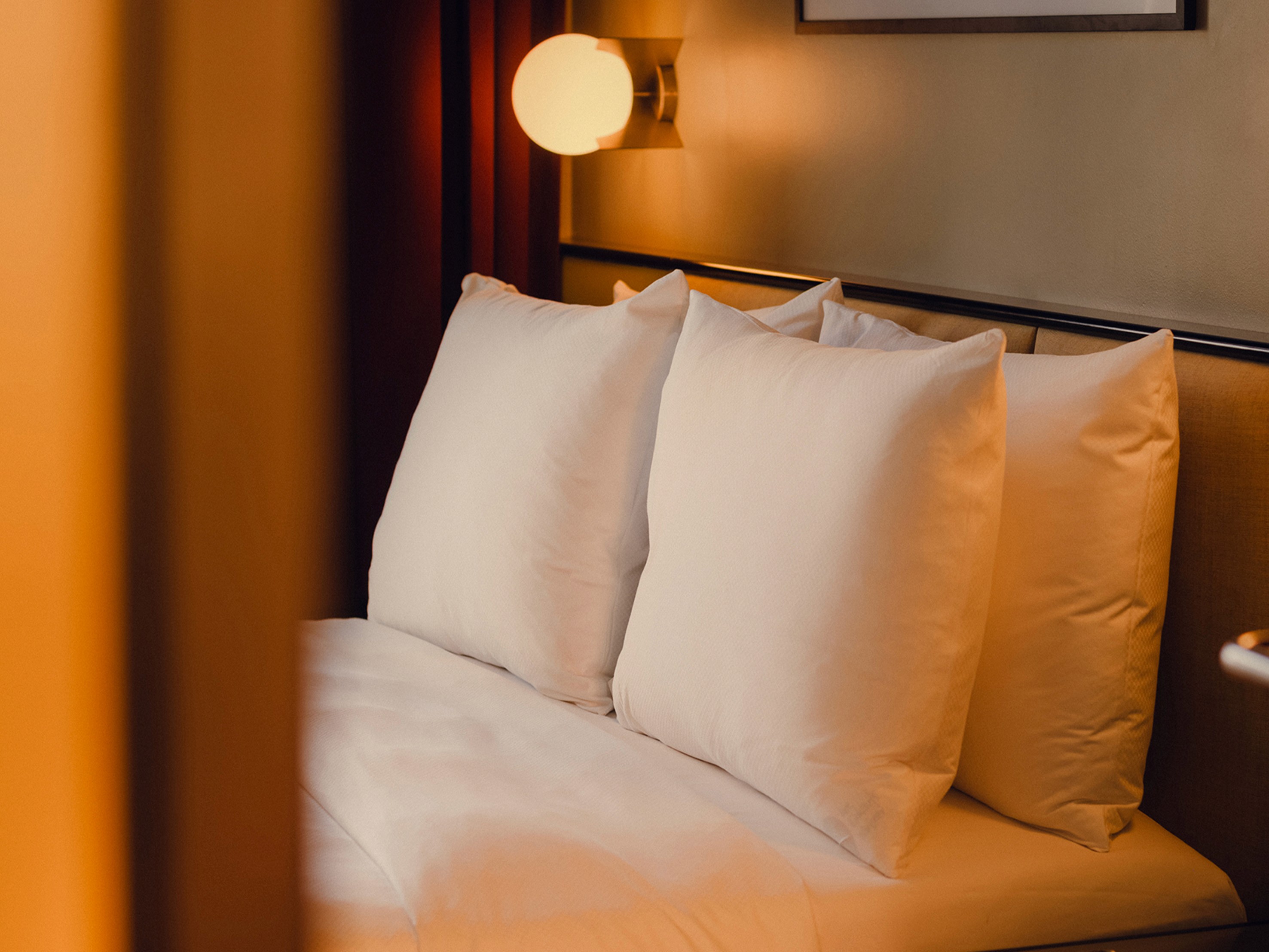 Neatly organised pillows at the Balcony Room at The Companion Vienna