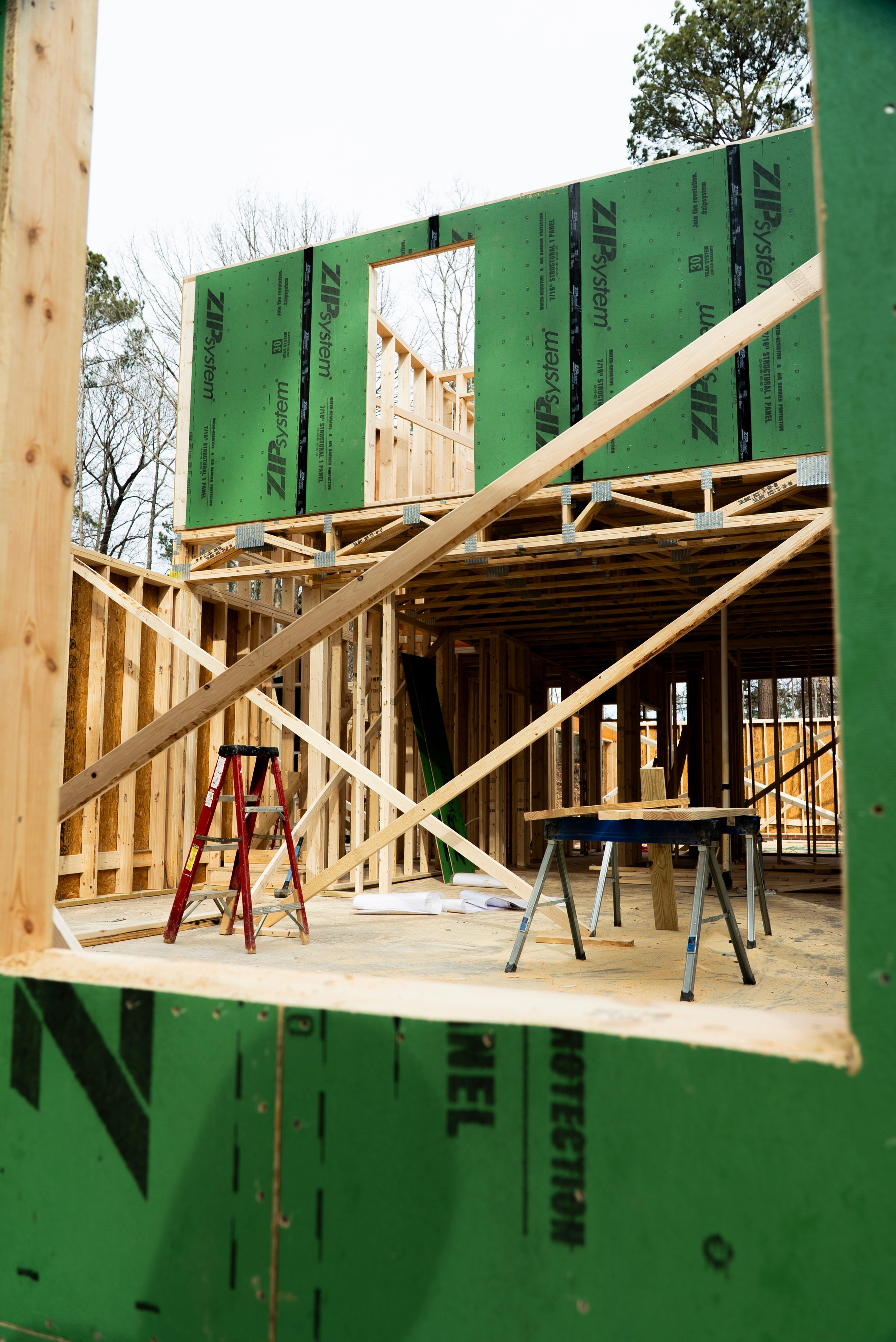 Interior wall framing with ZIP System sheathing before drywall installation on an SEGC build