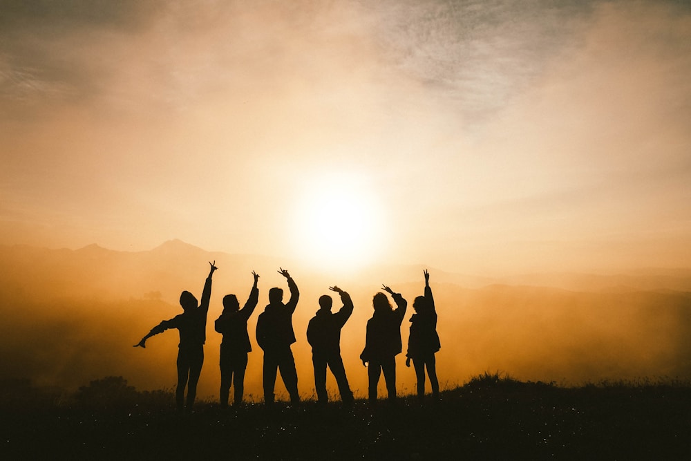 Community celebrating together at sunset