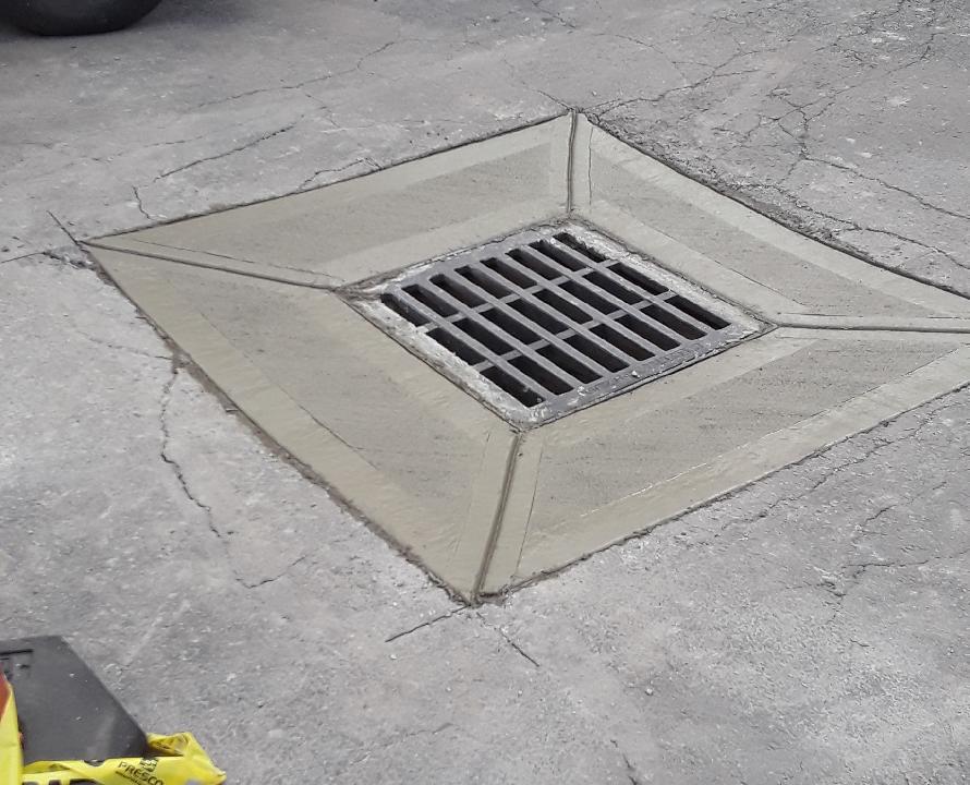 Blue underground utility pipe staged in an excavation area