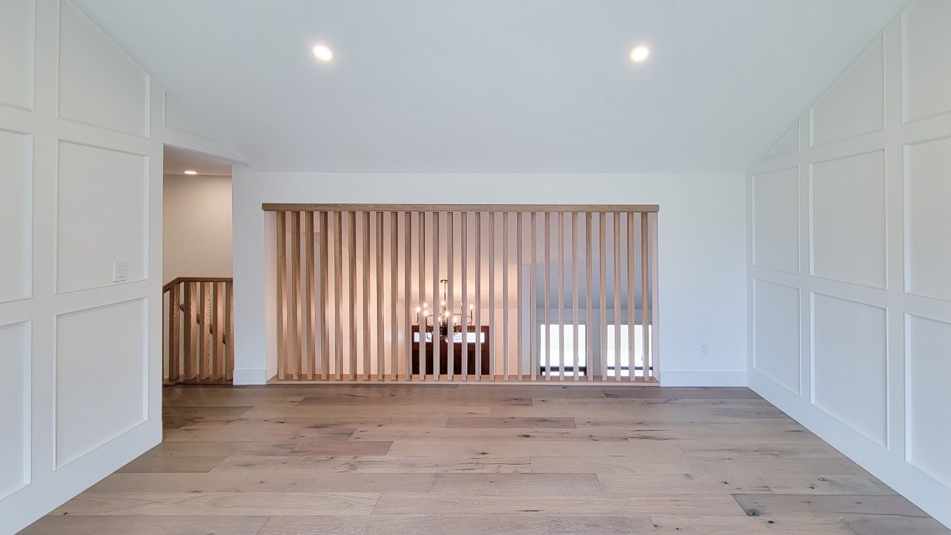 Image of KHD Homes interior design featuring wooden flooring, modern layout, and stylish room divider.