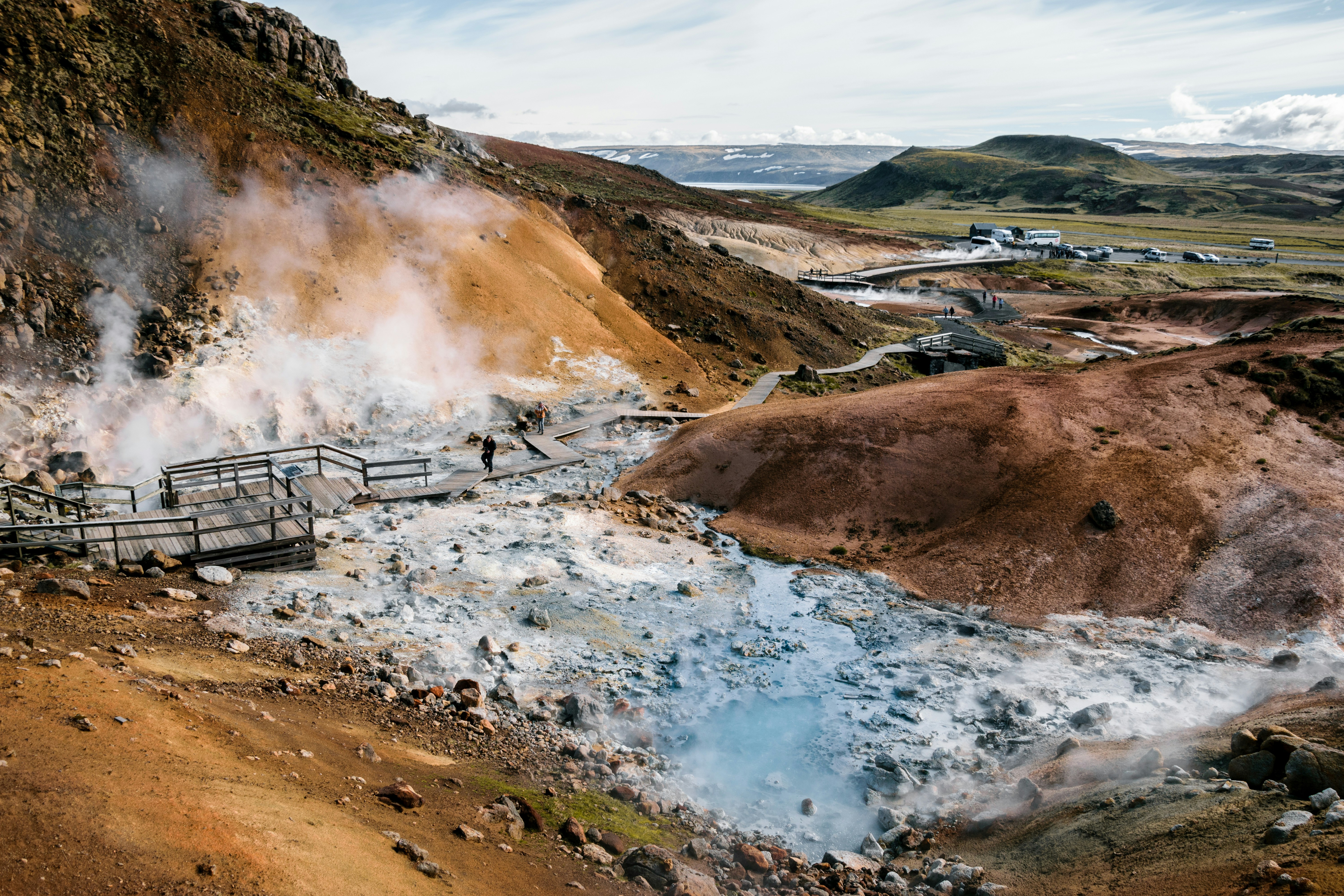 Steam rising from vibrant geothermal pools at Seltún in Iceland.