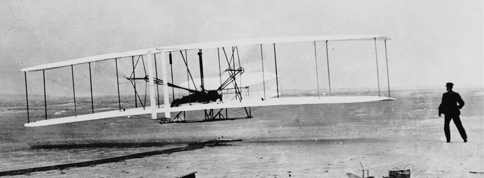 black and white photo of an early airplane test