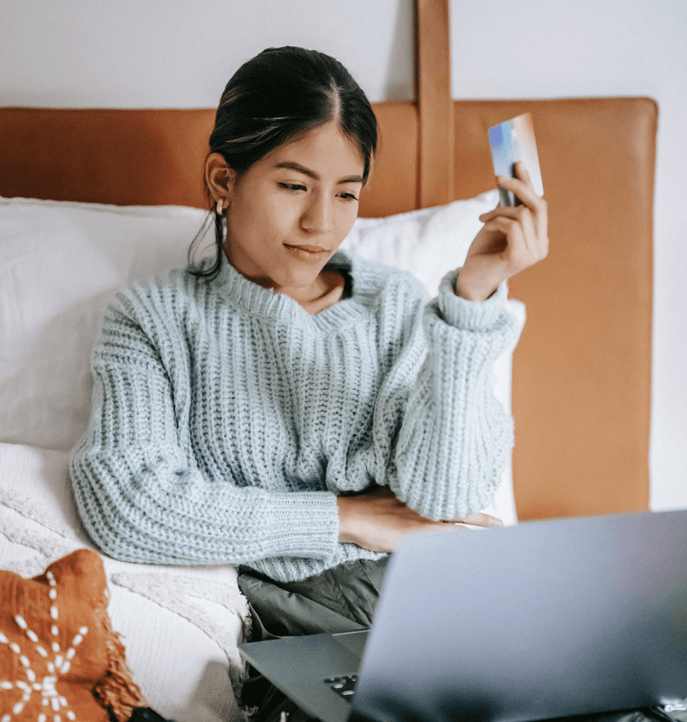 woman sitting on the floor with her laptop shopping for clothes online
