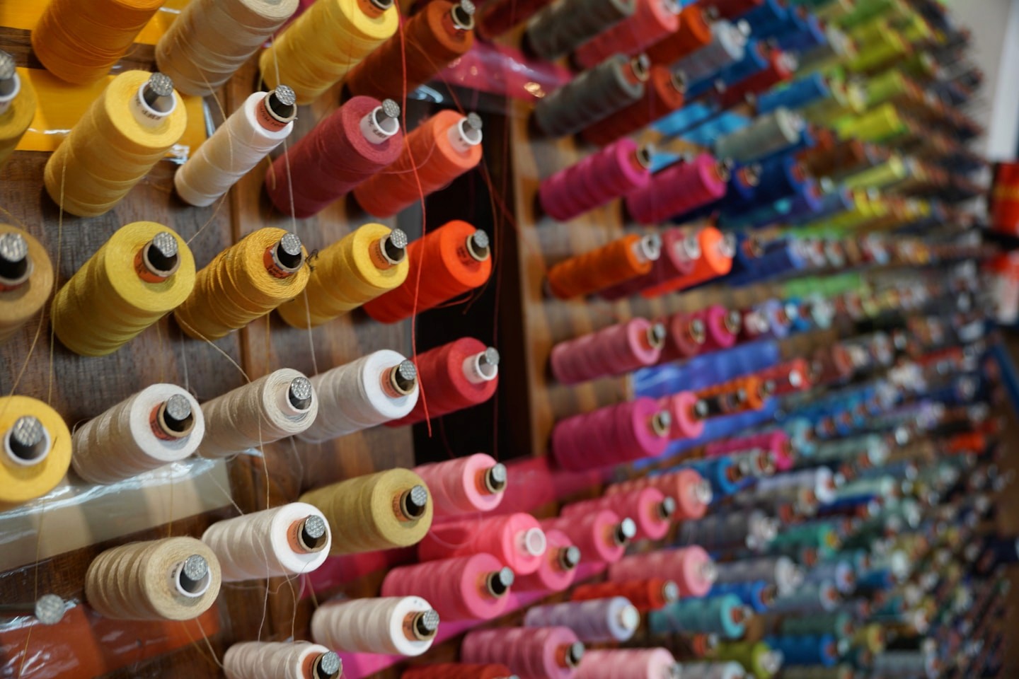 Cones of thread lining the workroom wall