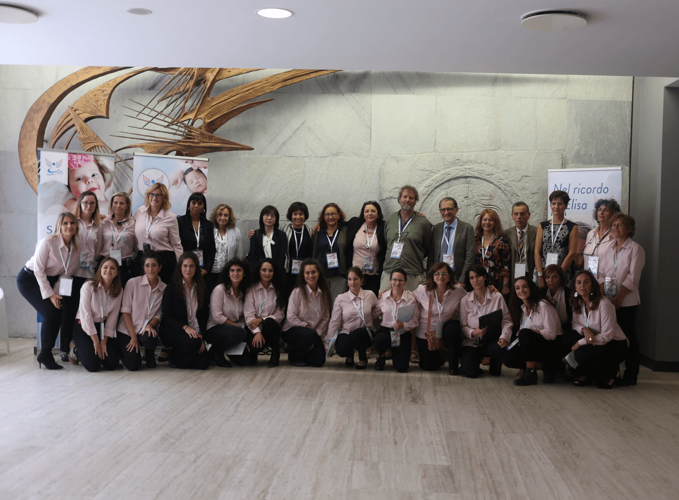 group of people standing near white wall