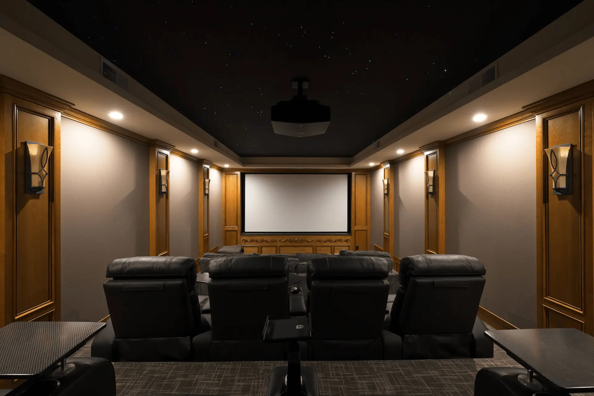 Wide view of the home theater room, featuring an awe-inspiring LED star constellation ceiling, creating a cinematic experience in the San Juan Capistrano remodel. Photo by Todd Huge.