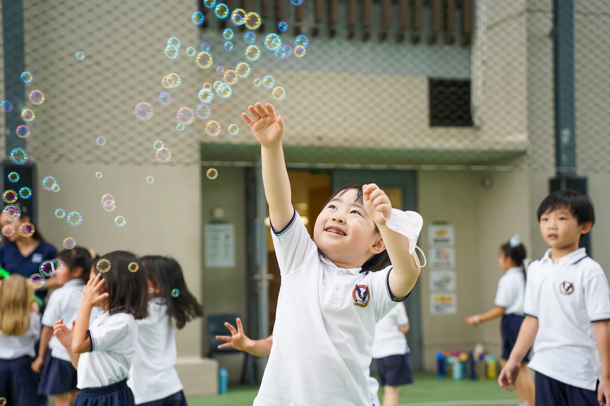 a man holding a microphone in front of a large group of people