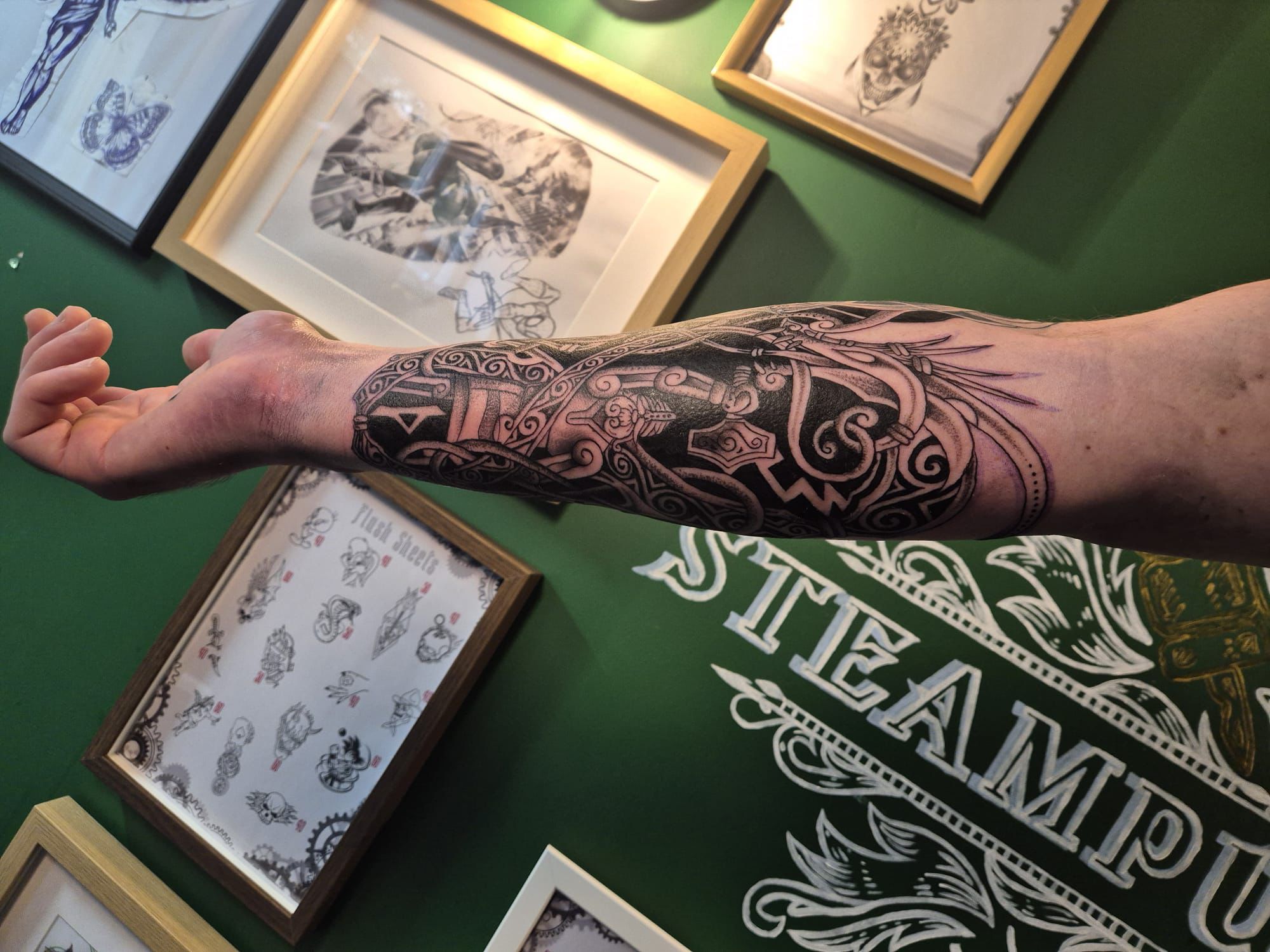 Skull and roses forearm tattoo in black and grey in Hazel Grove