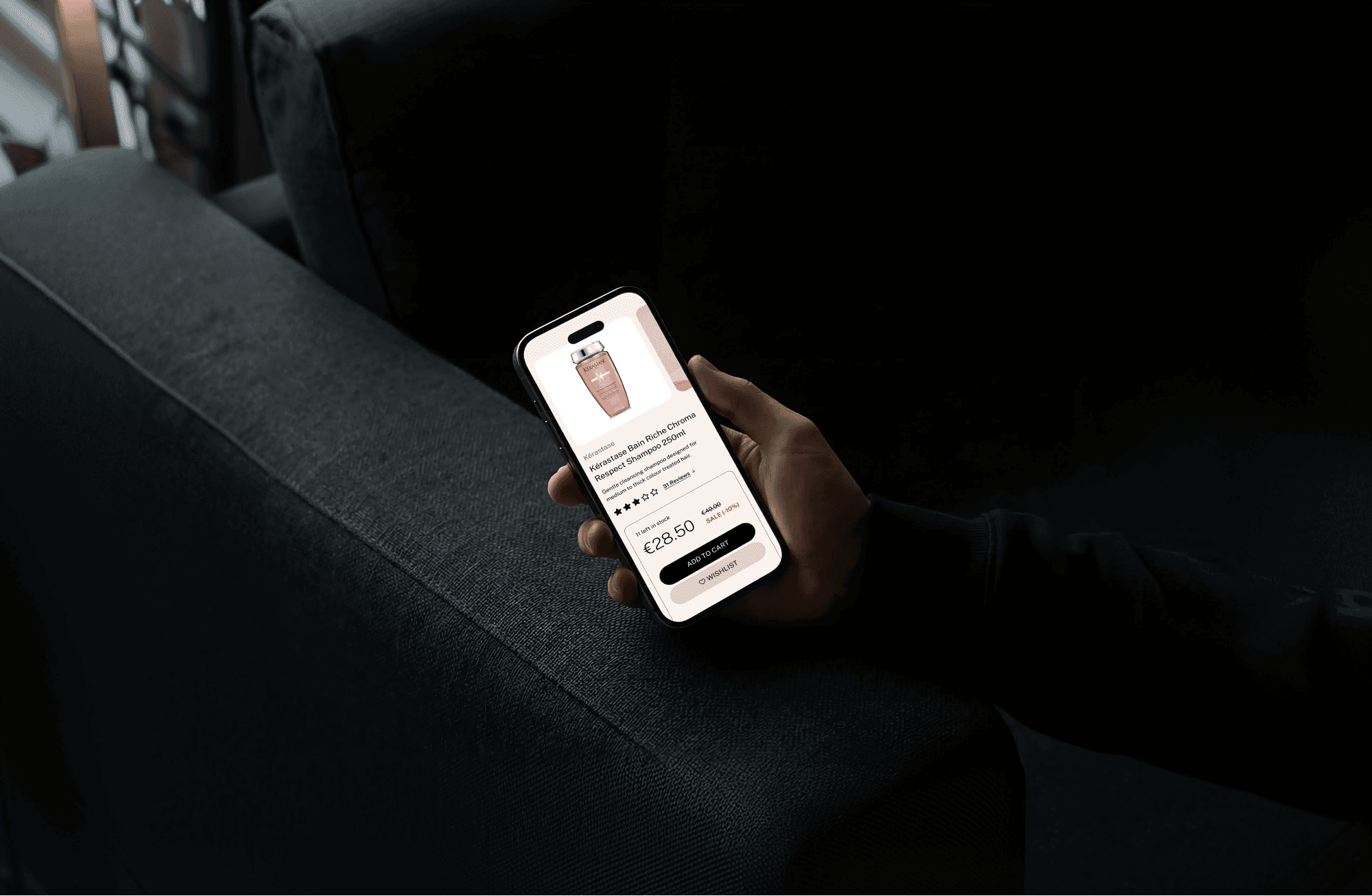 Man holding a phone browsing the Peter Mark mobile shop website