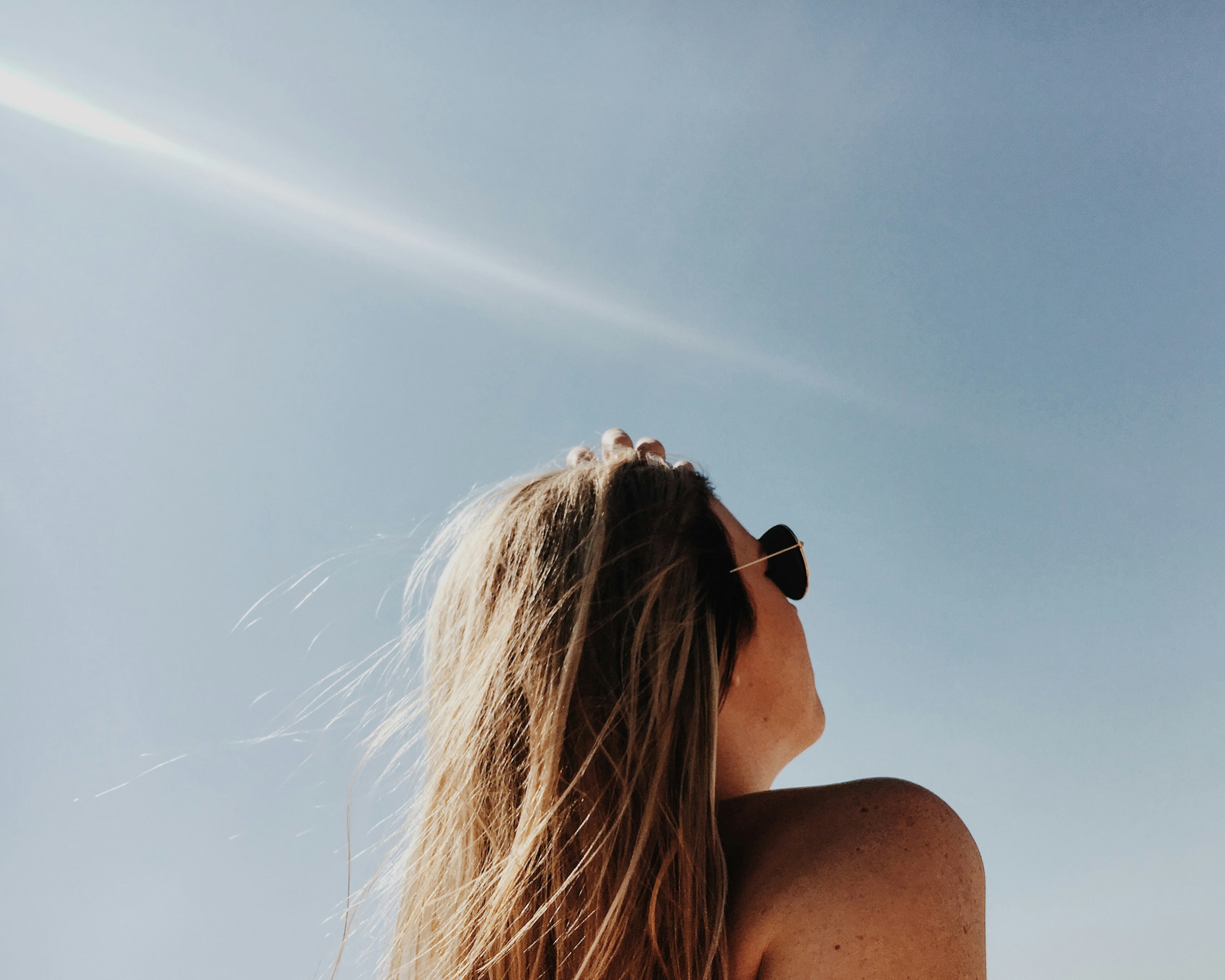 woman at a beach - Benefits of Morning Sunlight