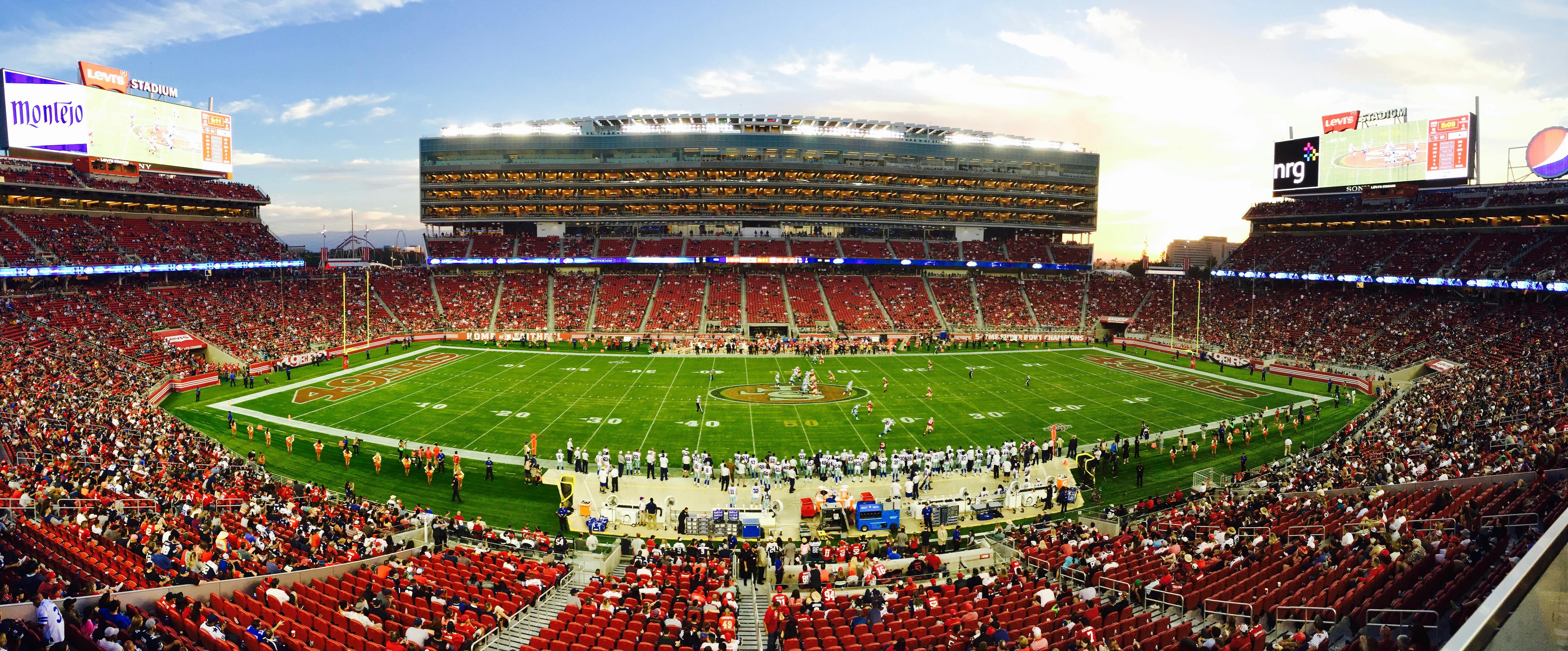 Football stadium with crowd watching during daytime