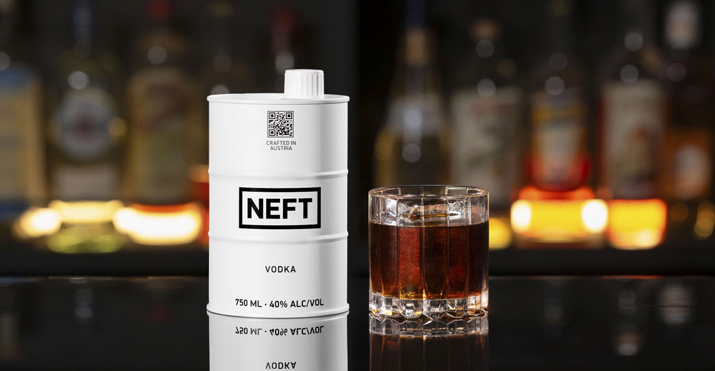 A NEFT Barrel and a glass of Black Russian on a bar counter.