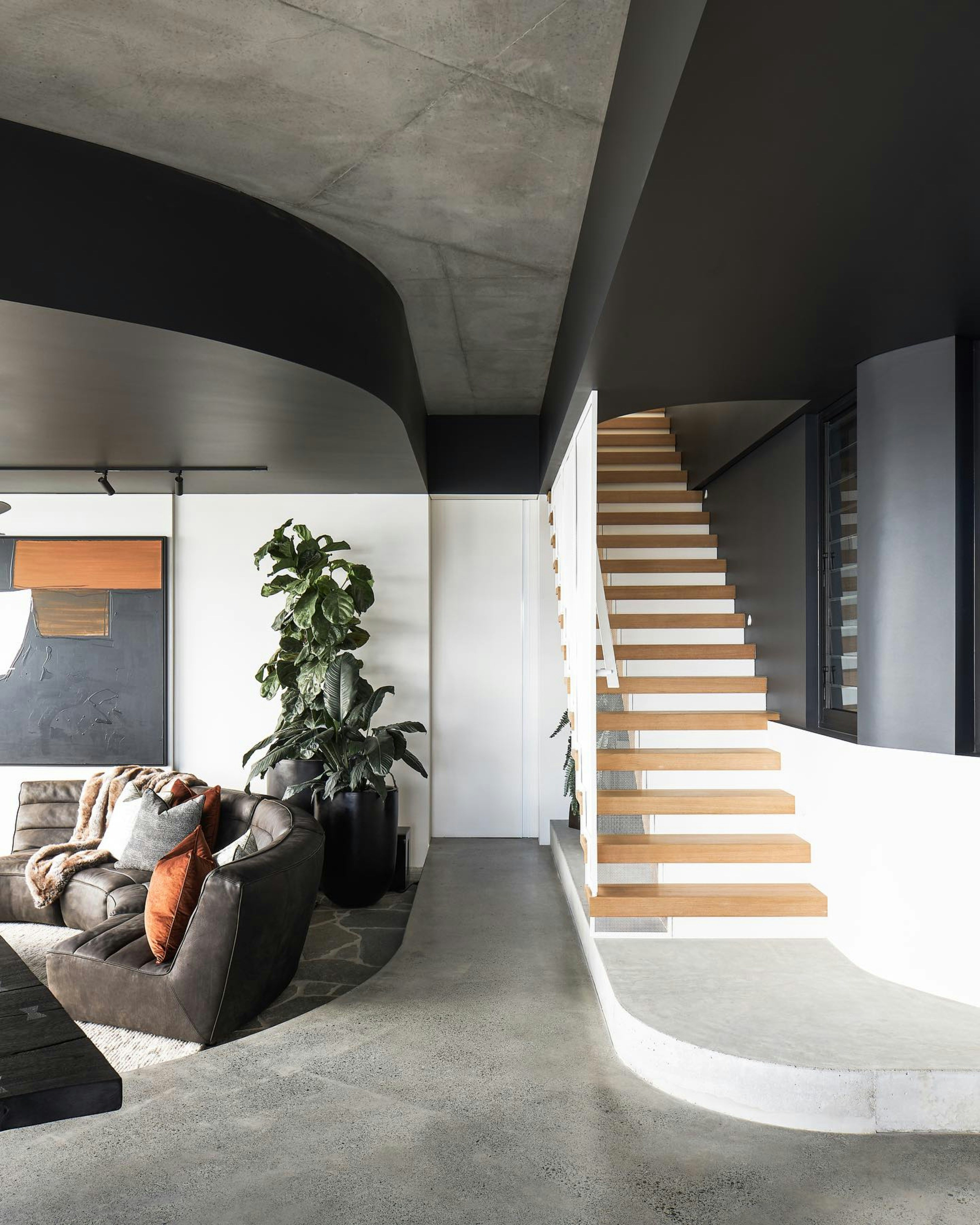 a living room filled with furniture and a staircase