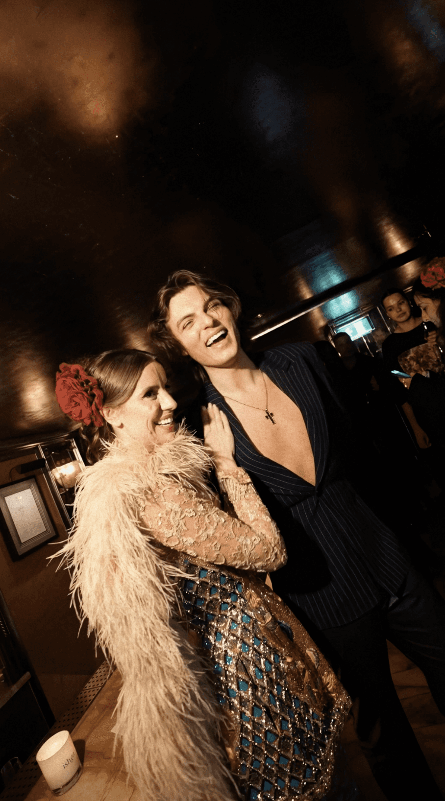 Bride and groom walking on street at night