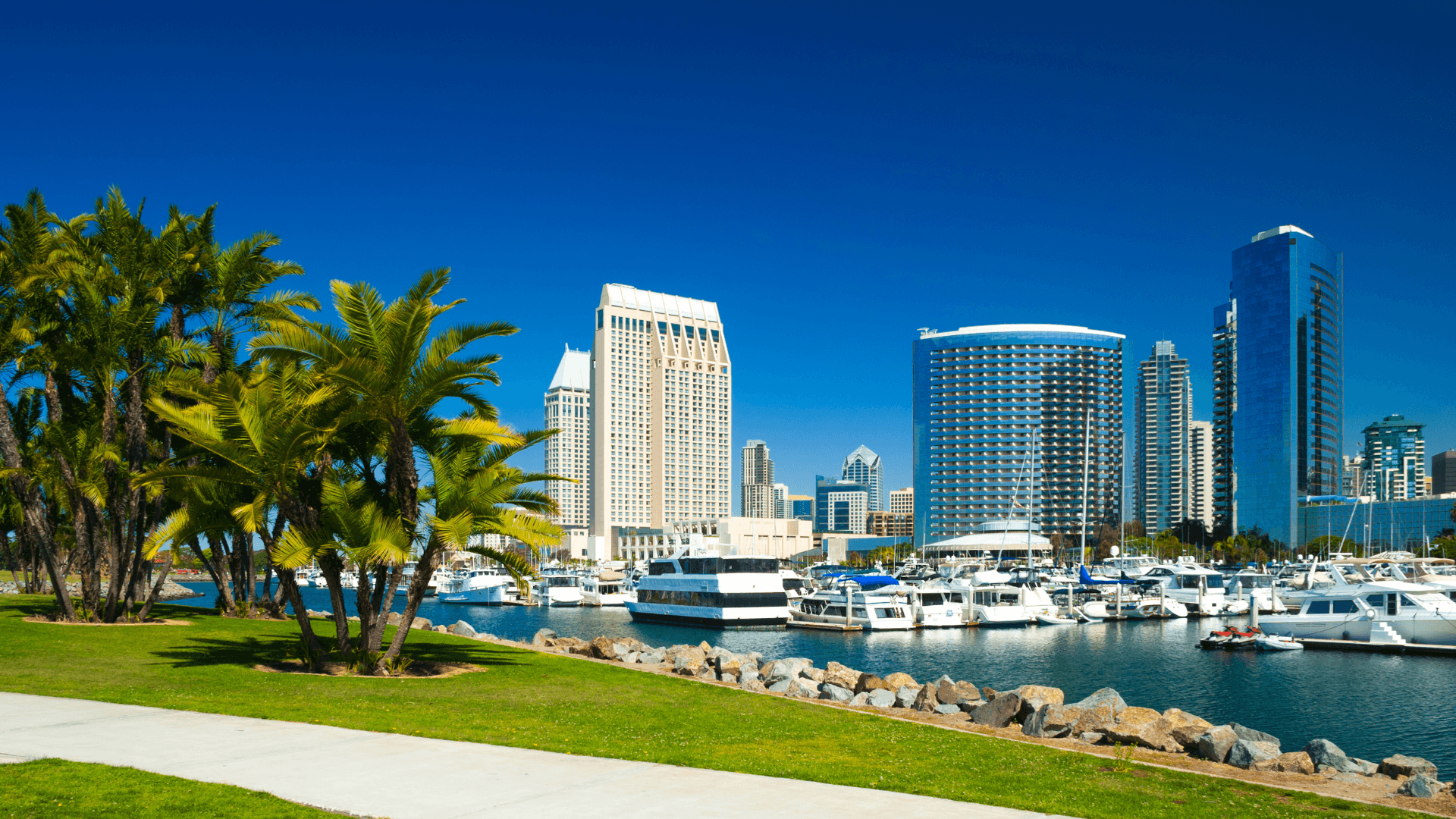  Collaborative work session overhead view of six people collaborating at a rustic wooden table with coffee, papers, and a laptop