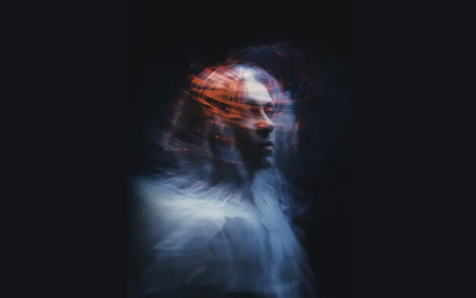 Portrait of a Man with Long Hair on a Black Background under Surrealist Blurred Lens