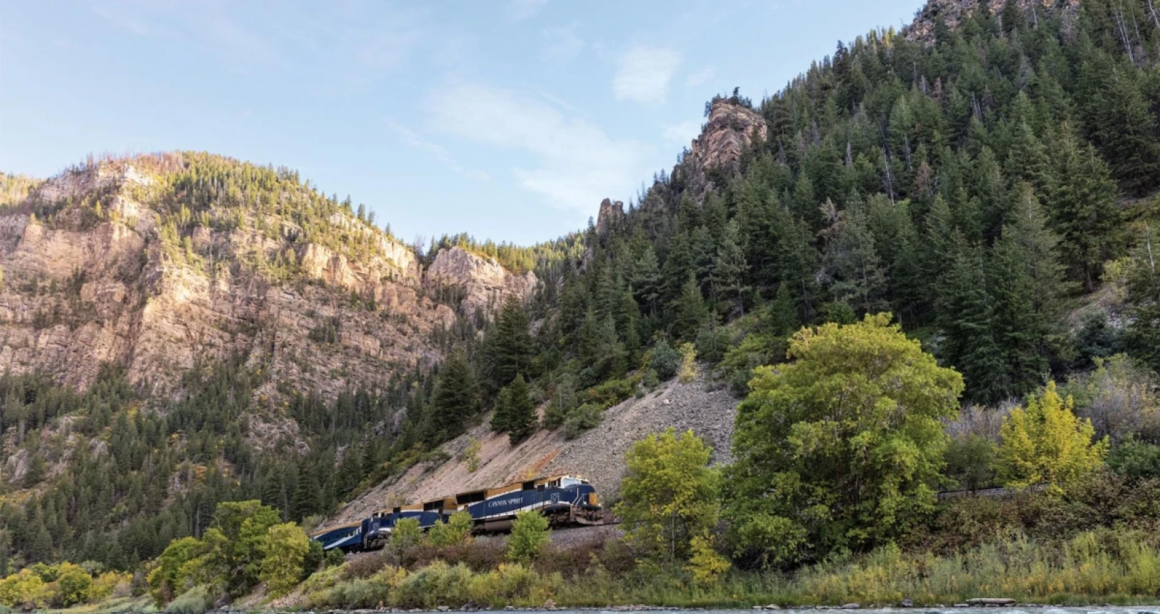 The Canyon Spirit train passing Grizzly Creek in Colorado, on the Rockies to the Red Rocks route
