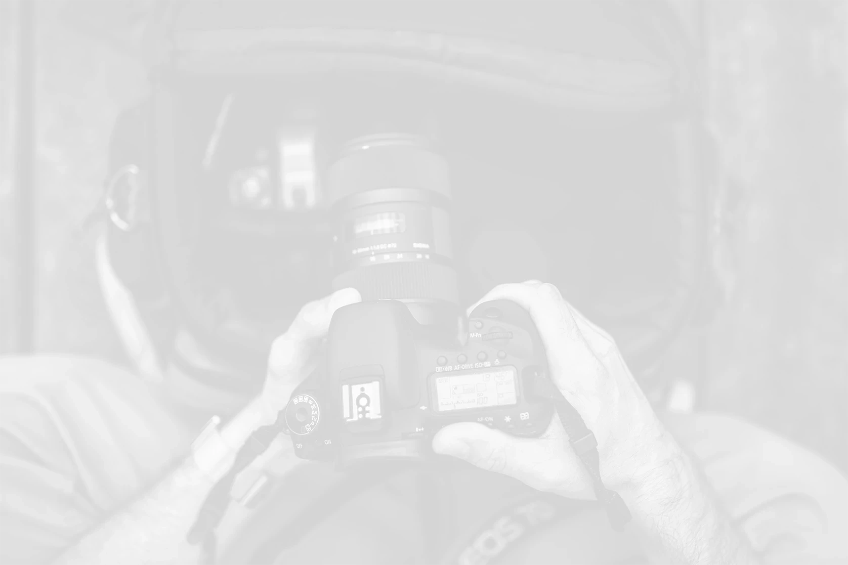 volume-photographer-holding-camera-background