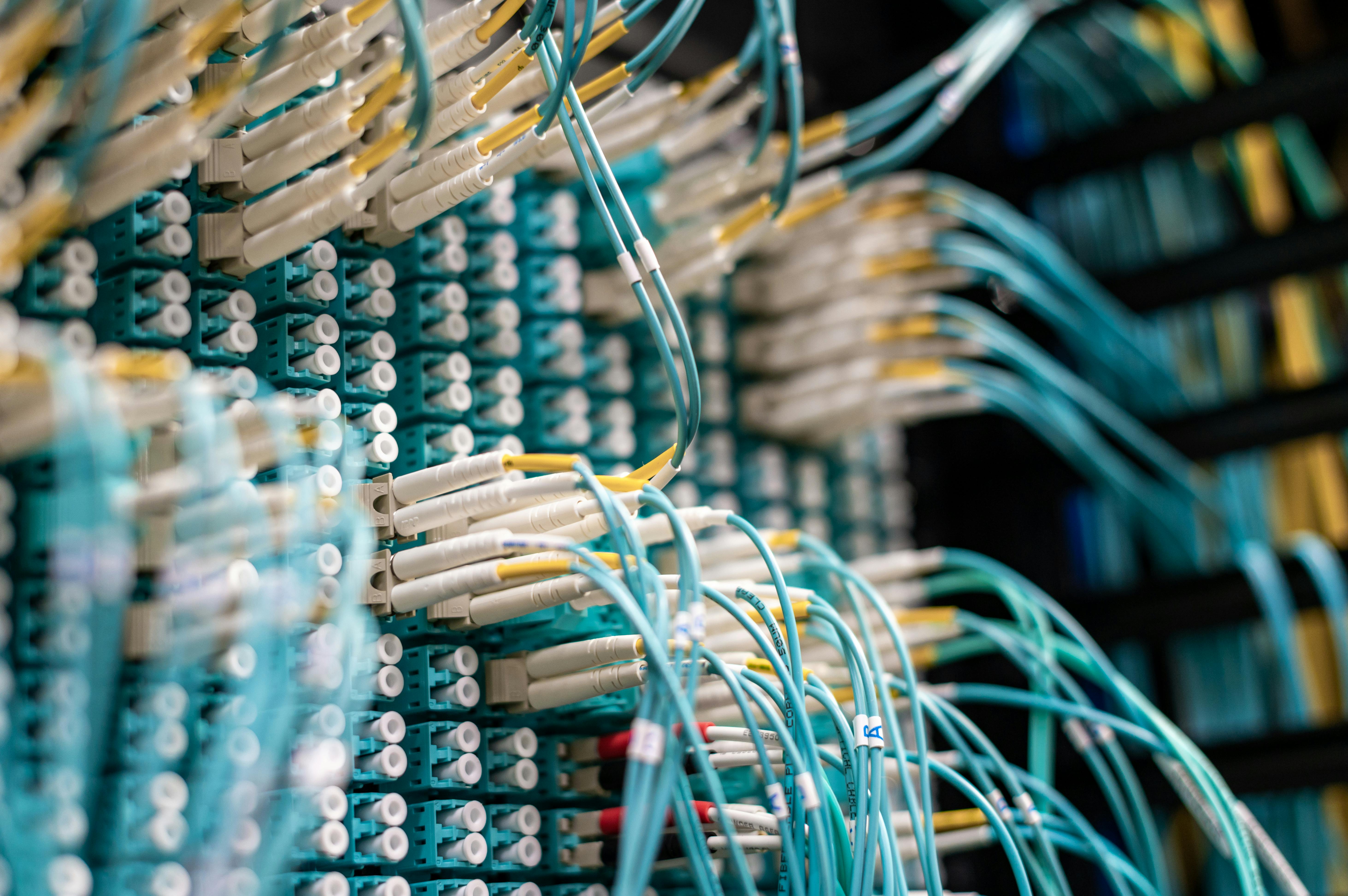 Connessioni in fibra ottica in un data center, rappresentazione delle infrastrutture che rendono possibile il cloud computing e il trasferimento sicuro dei dati.