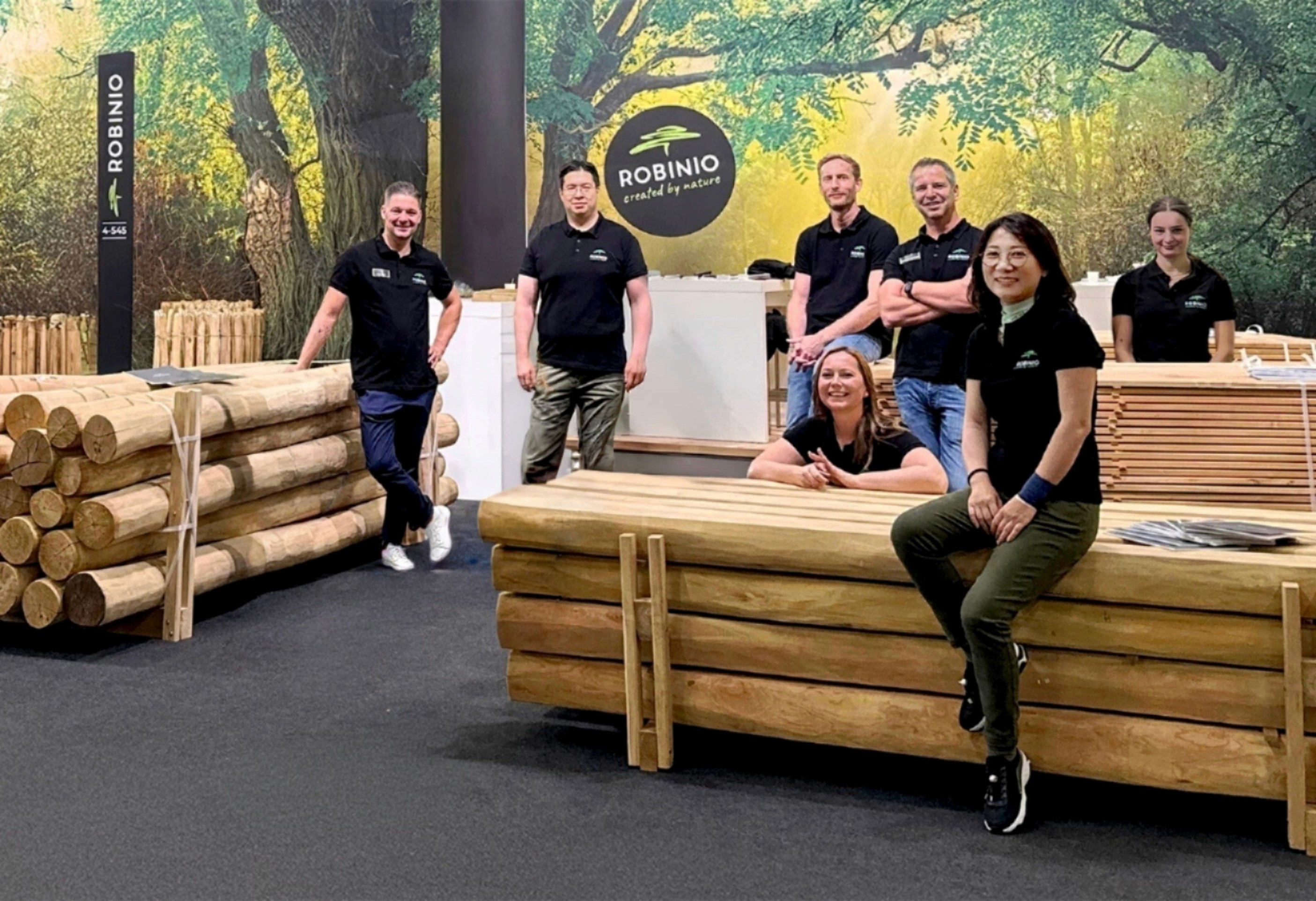 ROBINIO Team am Messestand mit Robinien-Rundhölzern – persönliche Beratung für Spielplatzbau & Export; direkter Ansprechpartner statt Callcenter.