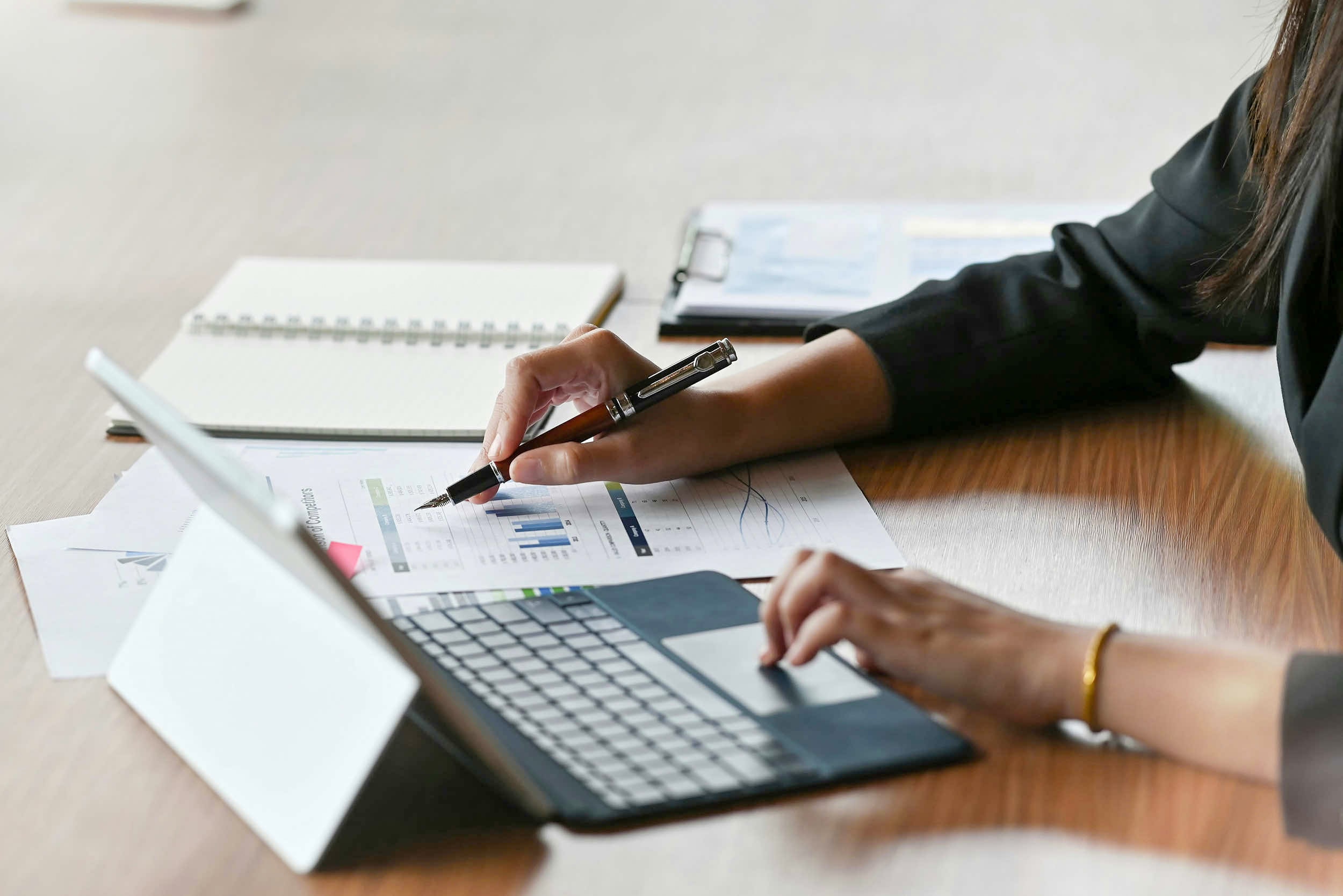 woman completing a financial audit at a desk