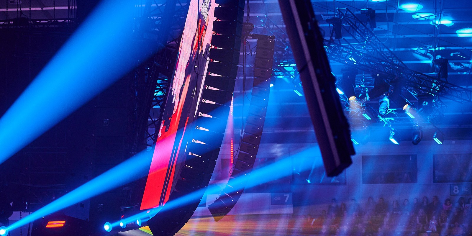Stage speaker array with blue spotlights.