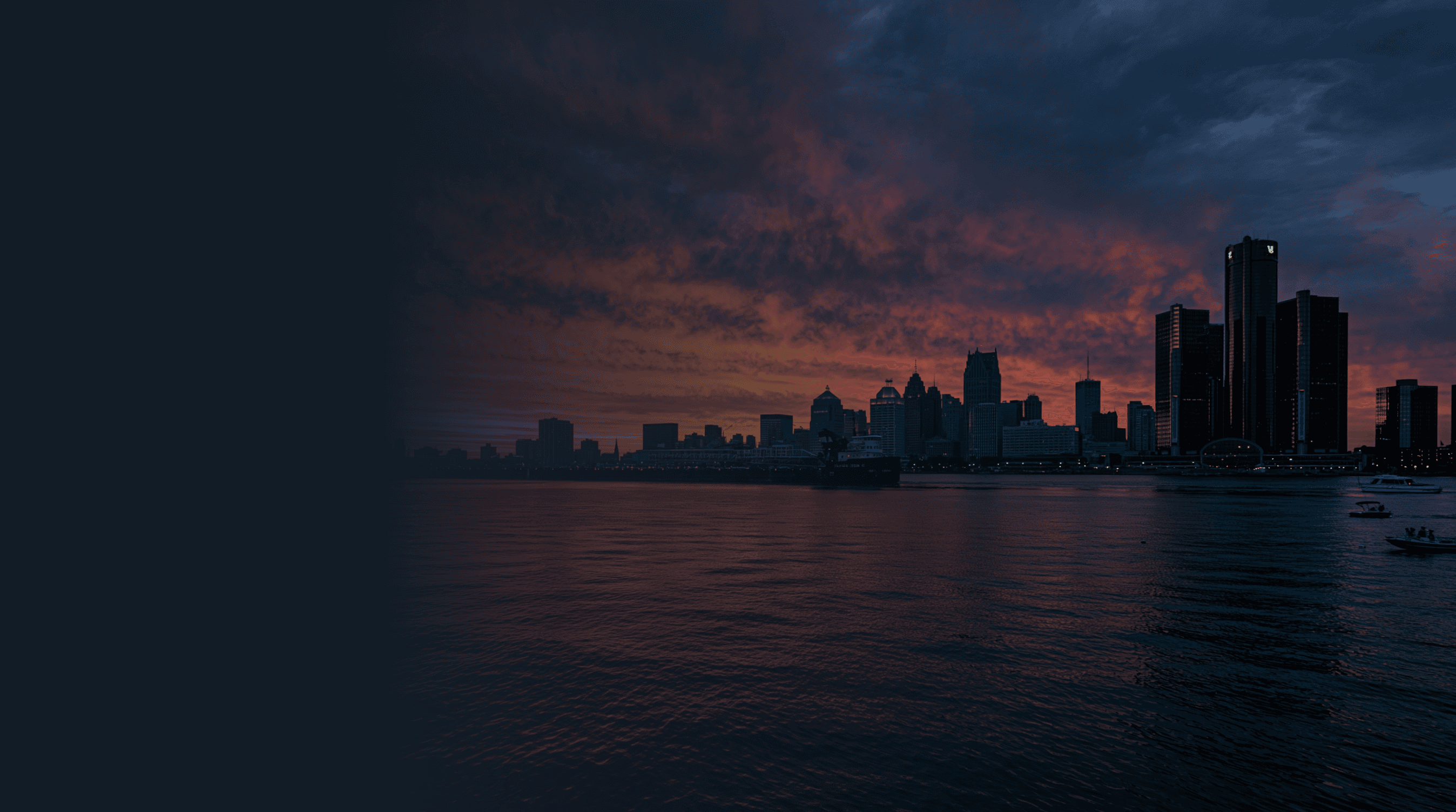 Aerial view of the Detroit River with Detroit skyline at sunset