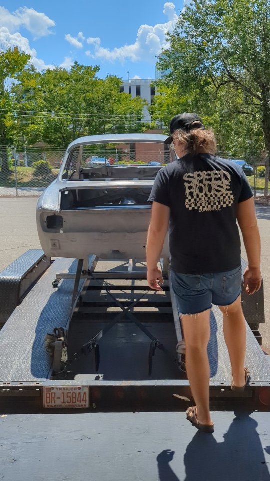 Luxury cars parked inside store.