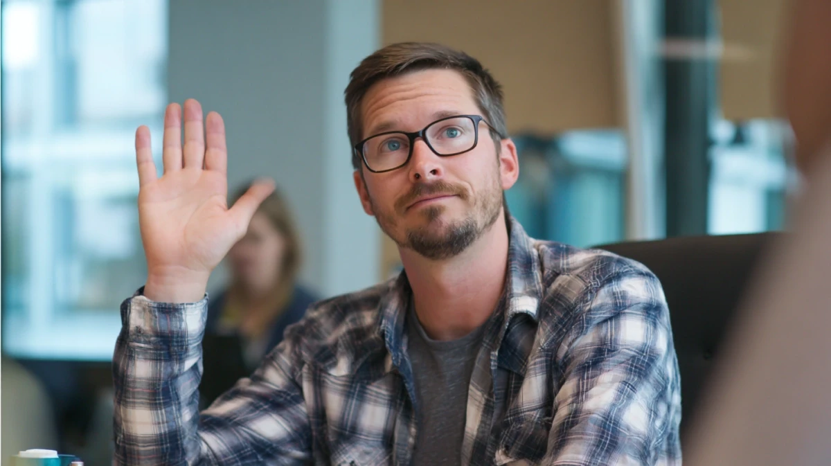 Man pausing during workplace conversation