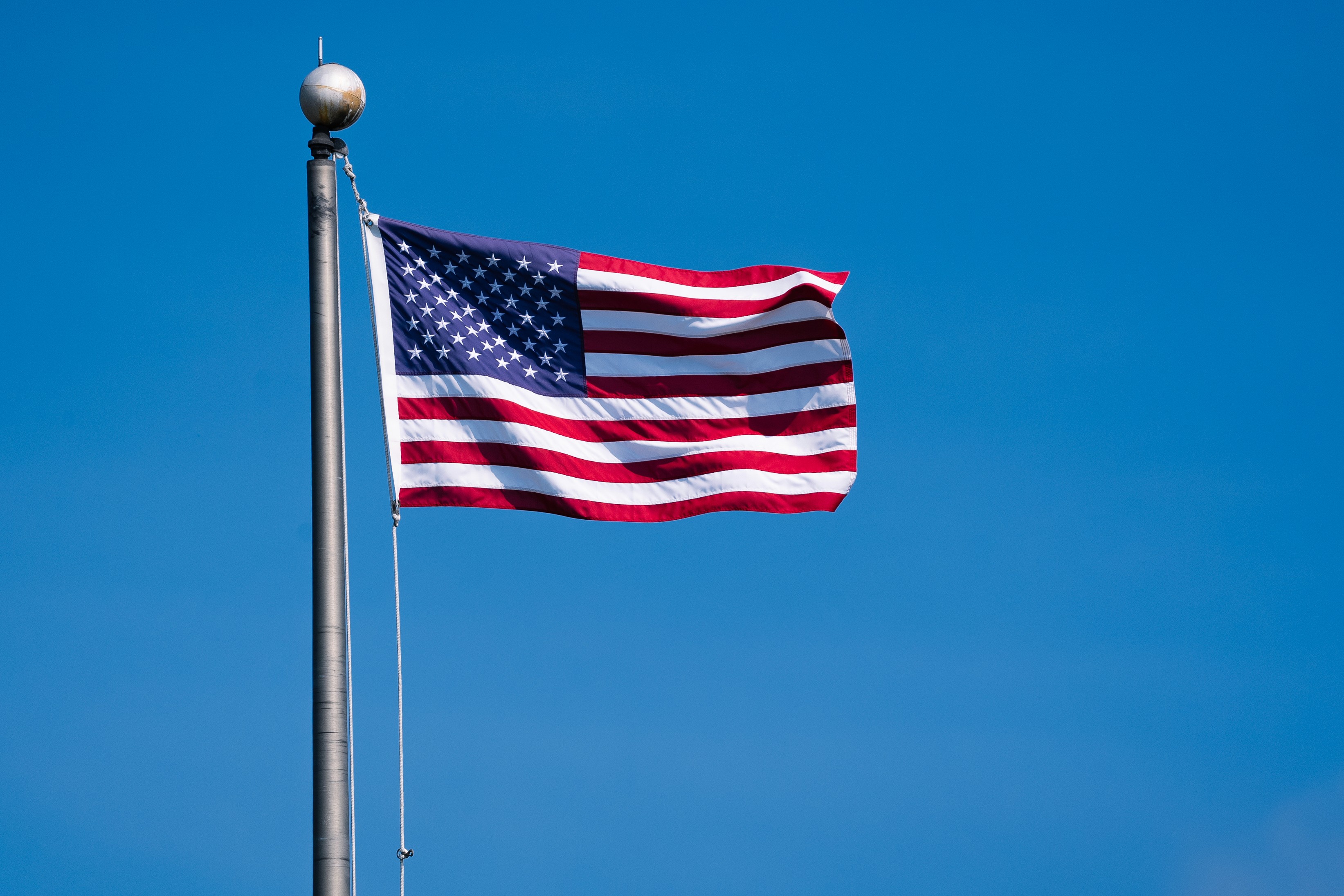 American flag waving in the Charleston summer breeze, symbolizing Fourth of July in Charleston, South Carolina.