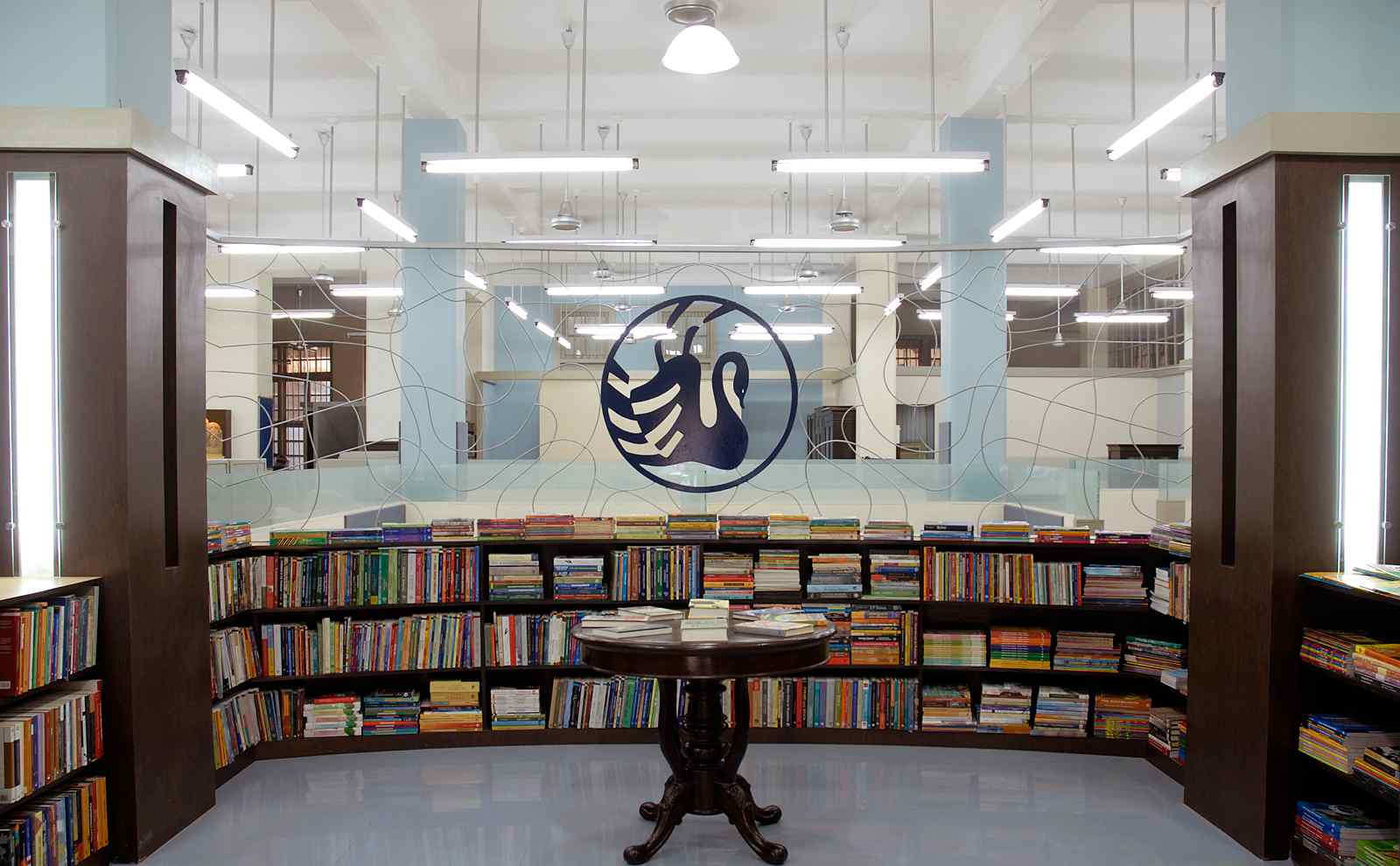 publishing company office interior with desks and library style shelving