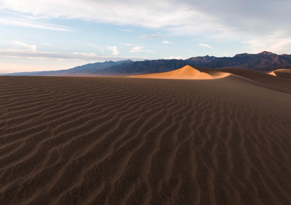 three brown wooden boat on blue lake water taken at daytime