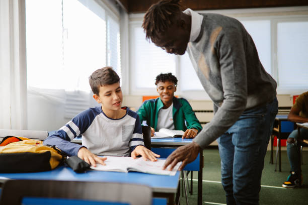 woman in blue tank top standing beside white wall
