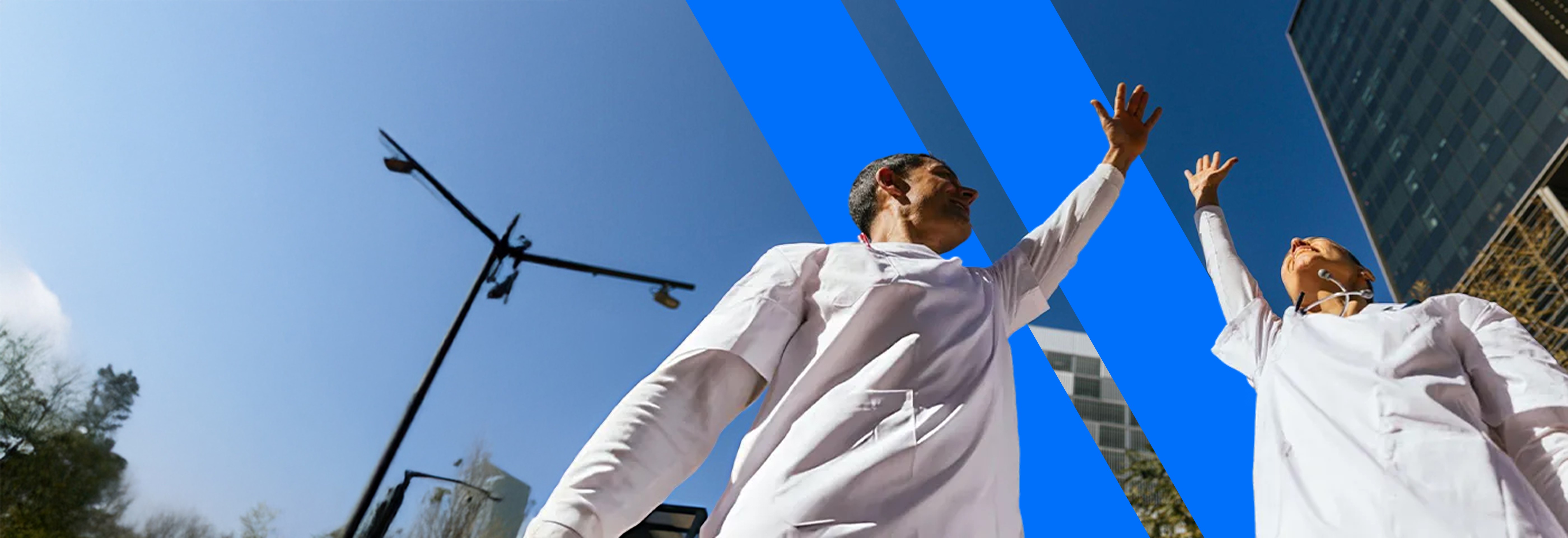 two people in a workspace working on their laptops