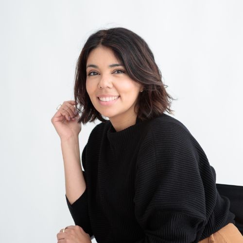 Patricia Ordoñez, Freelance Designer founder of Rara Design Studio smiling at the camera