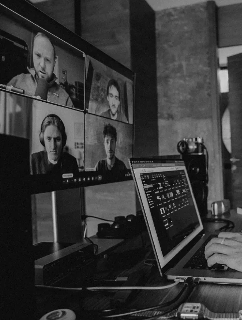 Reilin working behind his laptop while in a meeting