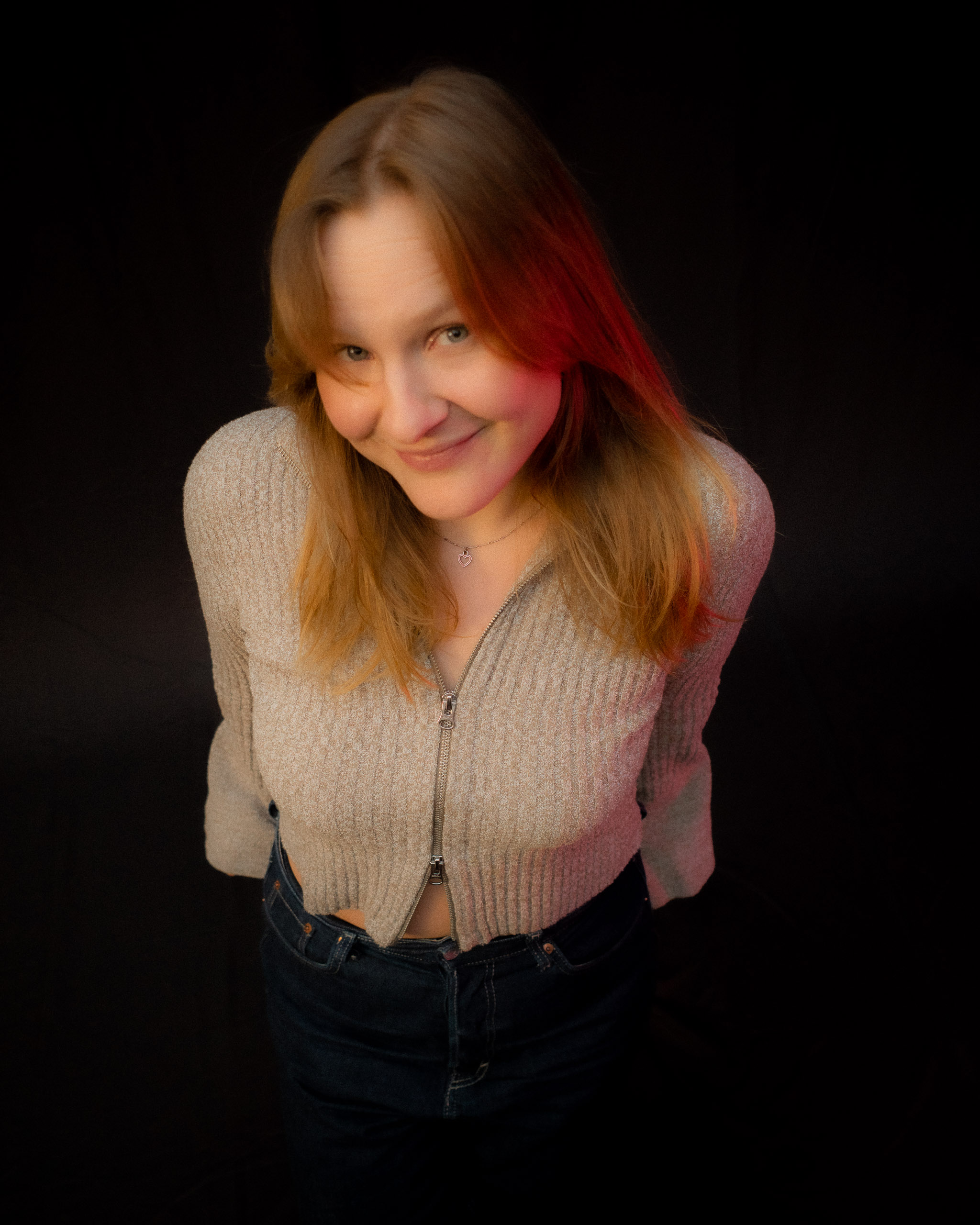 Young woman looking out a window at night