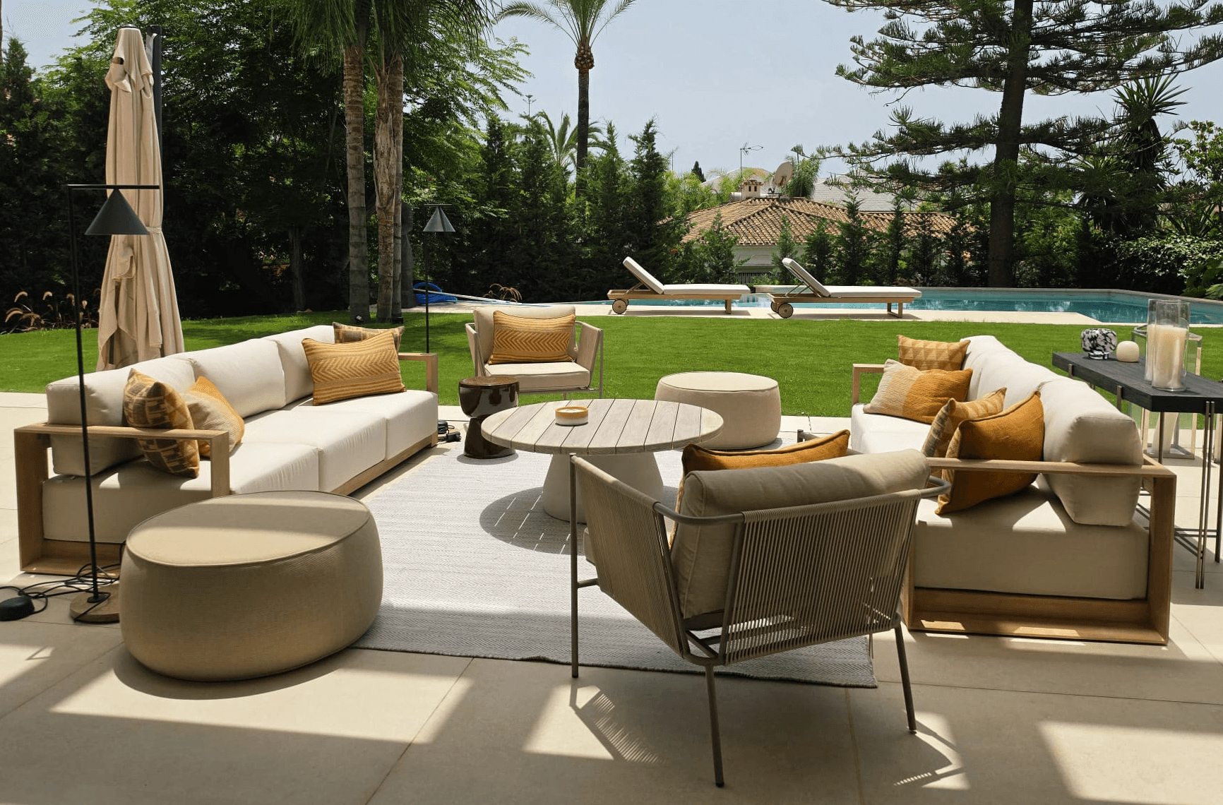 Marbella residence living room with neutral seating, artwork and warm timber detailing.