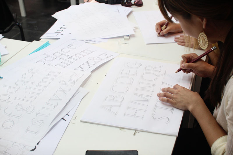 A photo of different pieces of paper with typographical letter designs.