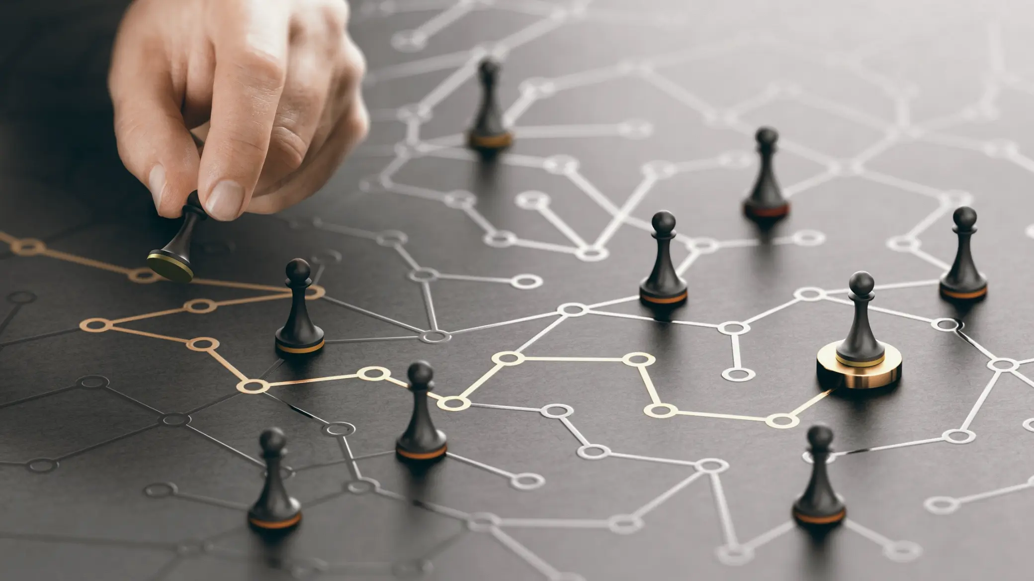 Hand moving a chess pawn across a network board of interconnected nodes, illustrating strategic decision-making and resource allocation