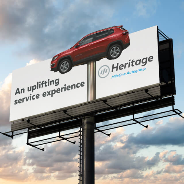 A billboard in Baltimore displays a red SUV elevated above the board, featuring An uplifting service experience, showcasing Heritage MileOne Autogroup’s brand strategy.